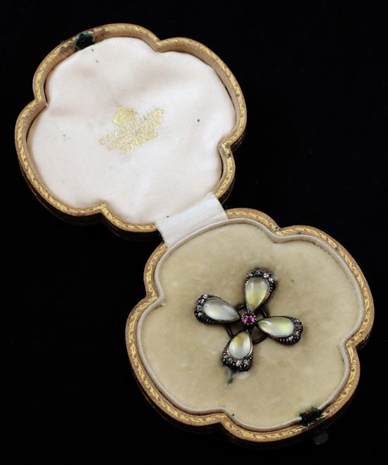 A late Victorian gold, moonstone, ruby and rose cut diamond brooch by Carlo & Arthur Giuliano, 1in.